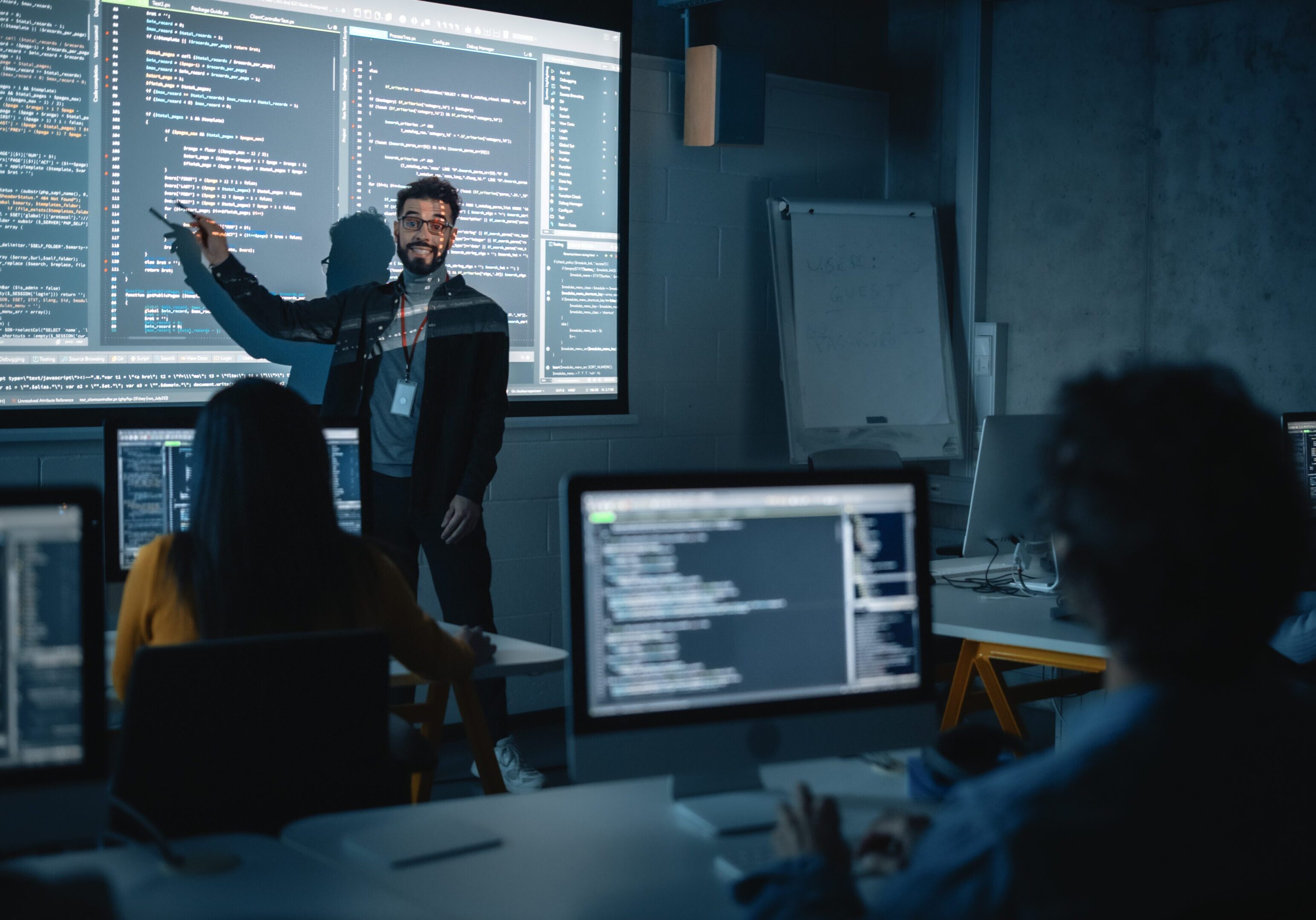 Instructor teaching programming in a classroom setting.