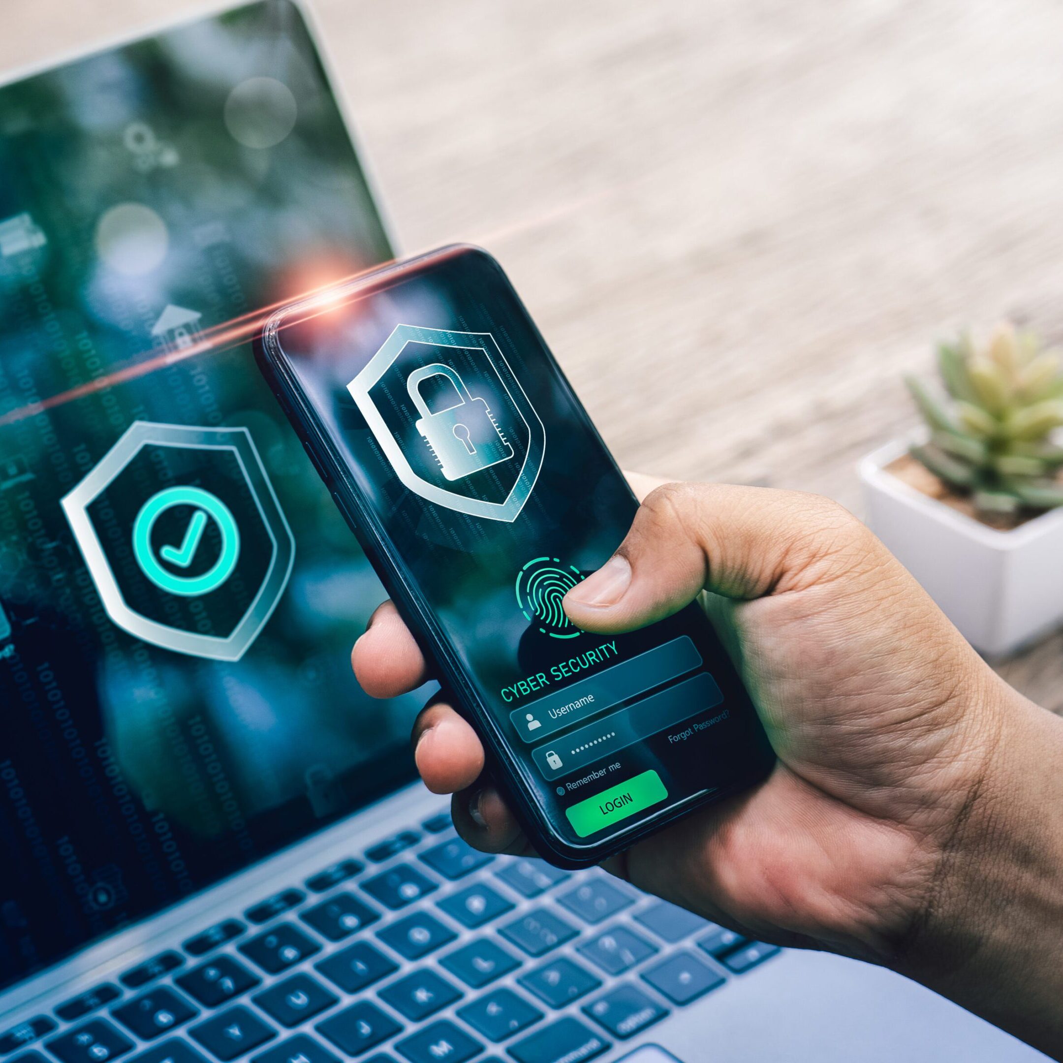 Phone and laptop with security apps displayed.