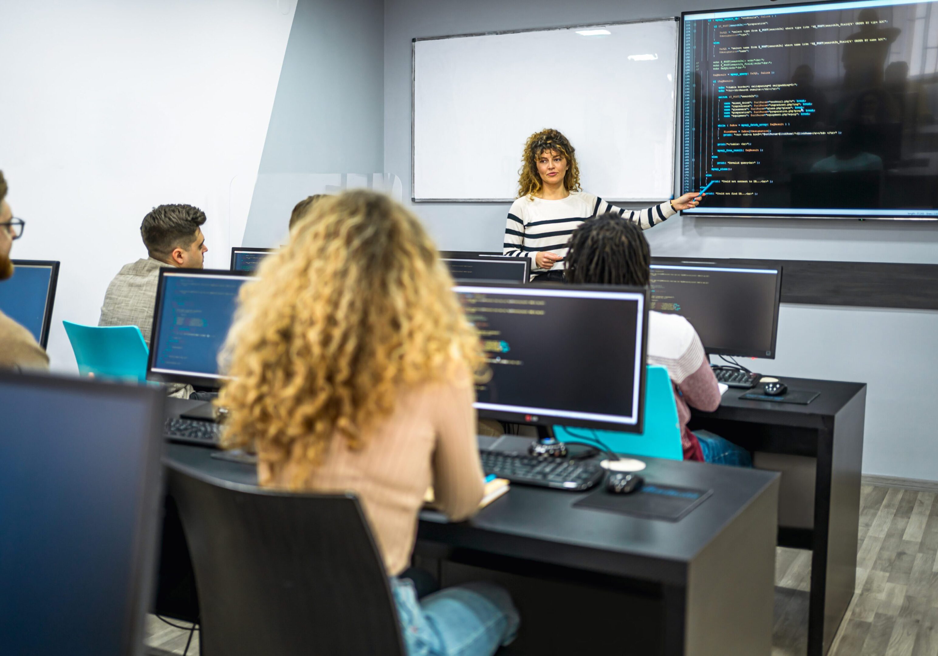 Classroom with students learning computer programming.