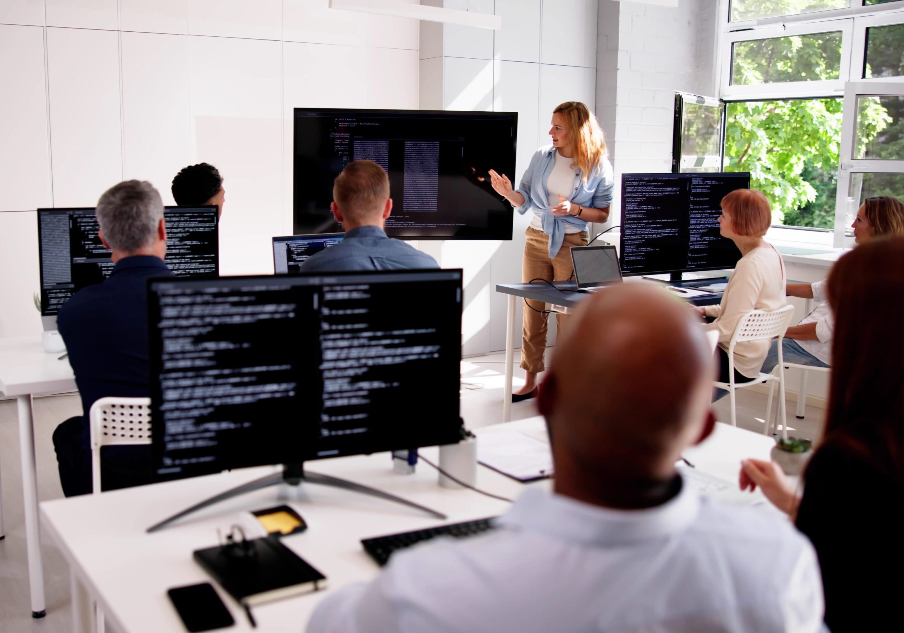 Classroom with instructor and students using computers.