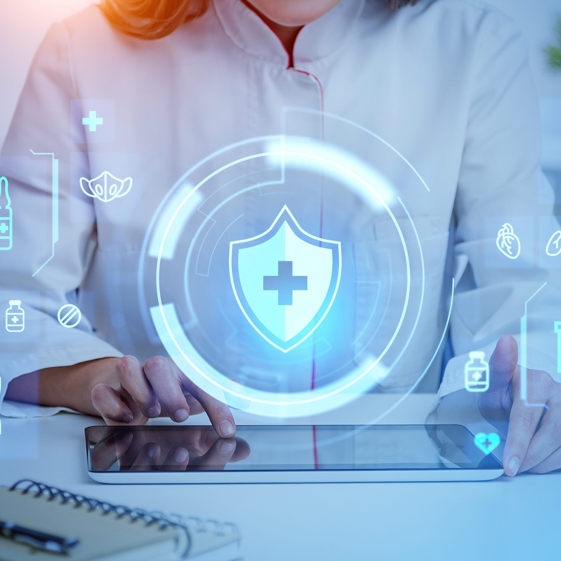 Healthcare professional using digital tablet with icons.